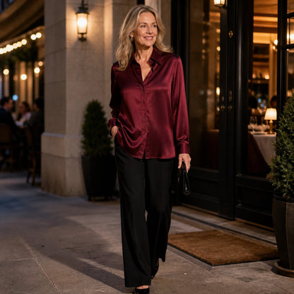 Woman wearing a burgundy satin blouse outside an upscale restaurant — view 8