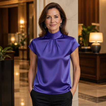 Violet high neck pleated satin blouse complete front view on a mature woman