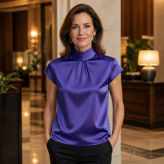 Violet high neck pleated satin blouse complete front view on a mature woman