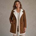 winter coat — Mature woman wearing chestnut brown faux suede ivory shearling trim longline coat front view