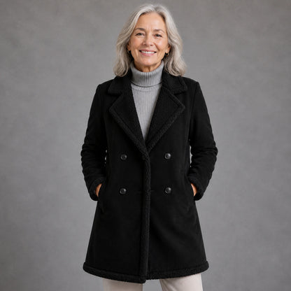 winter coat — Mature woman wearing black faux suede shearling trim longline coat front view — view 2