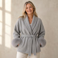 winter coat — Mature woman wearing pearl gray wool blend wrap coat with matching plush cuffs front view