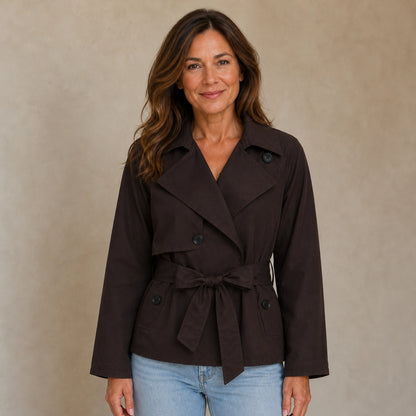 winter coat — Mature woman wearing dark chocolate cropped double breasted belted trench jacket front view