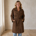 winter coat — Mature woman wearing chocolate brown faux suede double breasted belted trench coat front view