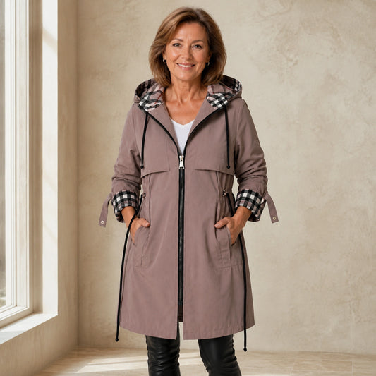winter coat — Mature woman wearing dusty taupe plaid lined adjustable hooded long coat front view
