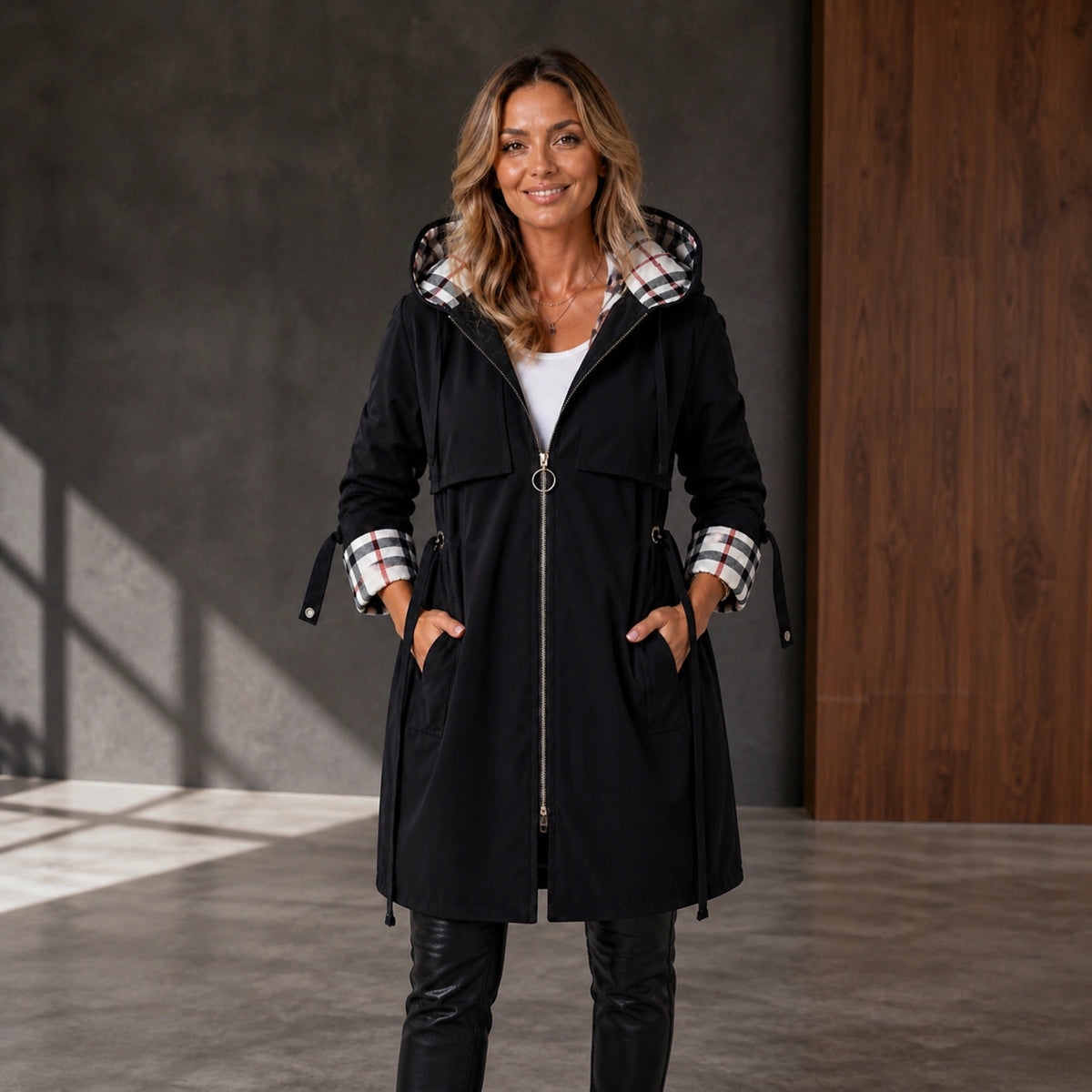 winter coat — Mature woman wearing black plaid lined adjustable hooded long coat front view — view 3