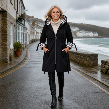 winter coat — Mature woman wearing black plaid lined hooded coat on a coastal town street — view 8